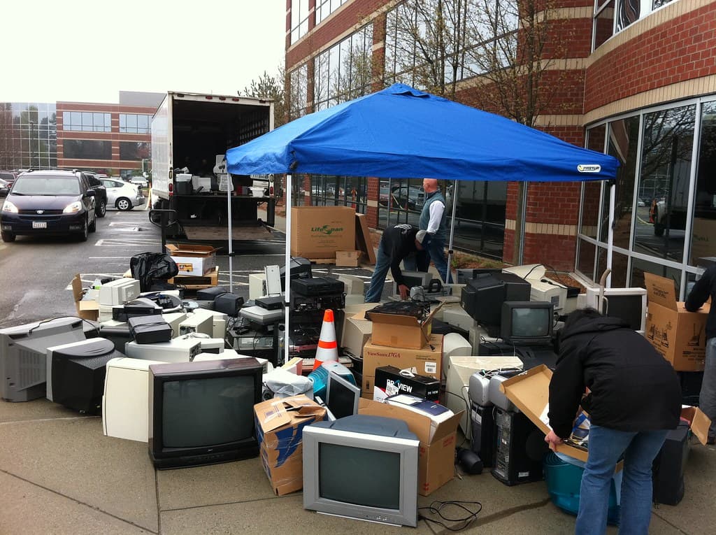 Collected office hardware and CRT monitors staged for organized pickup during an office exit
