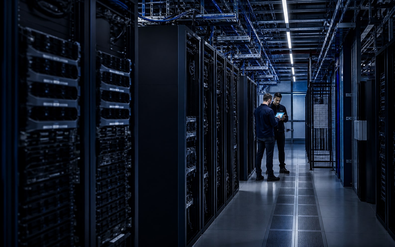 Technicians surveying a controlled aisle inside an enterprise data center